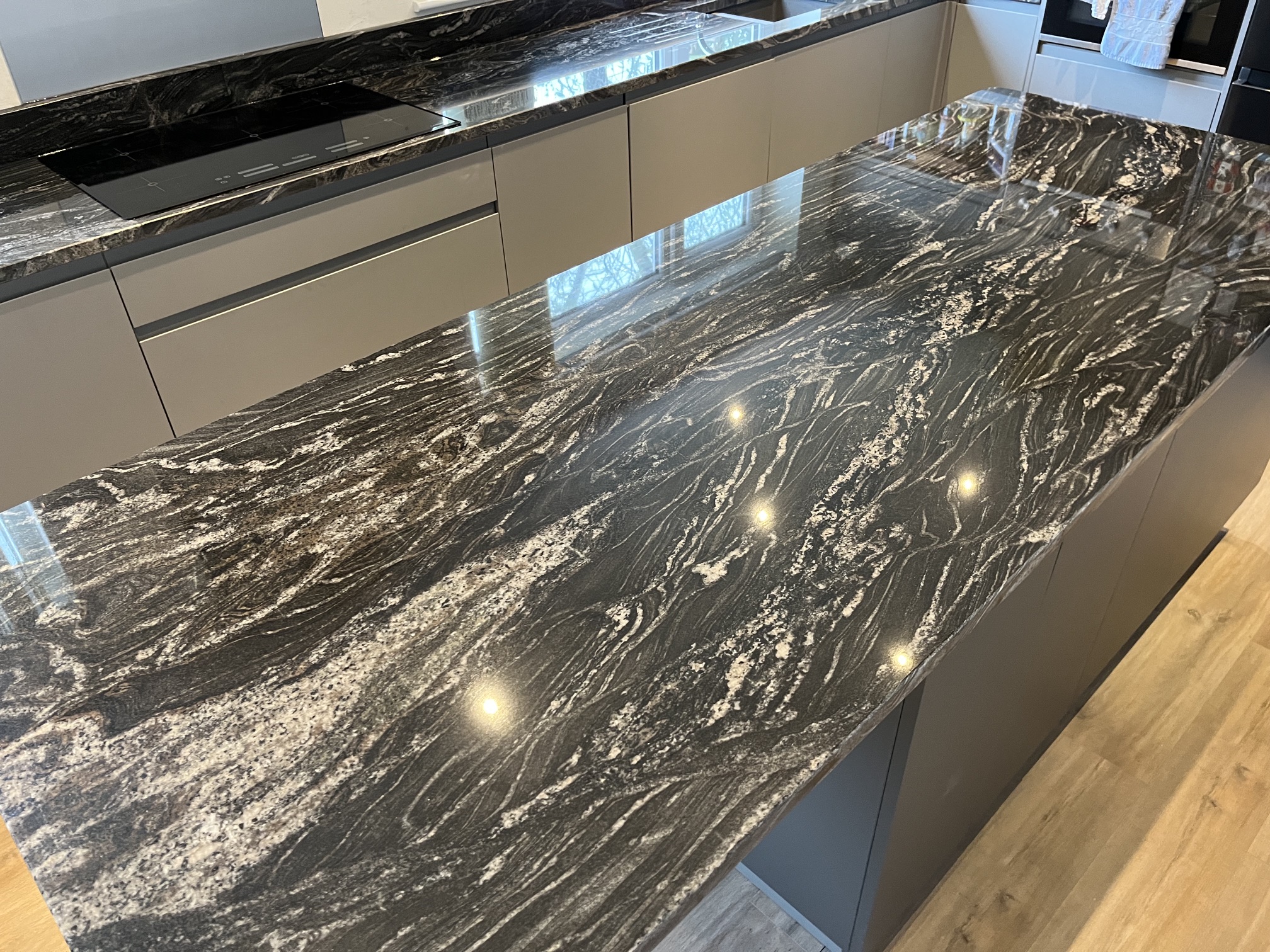 Black-and-white veined granite island with a seating overhang and matching worktops in Halifax.