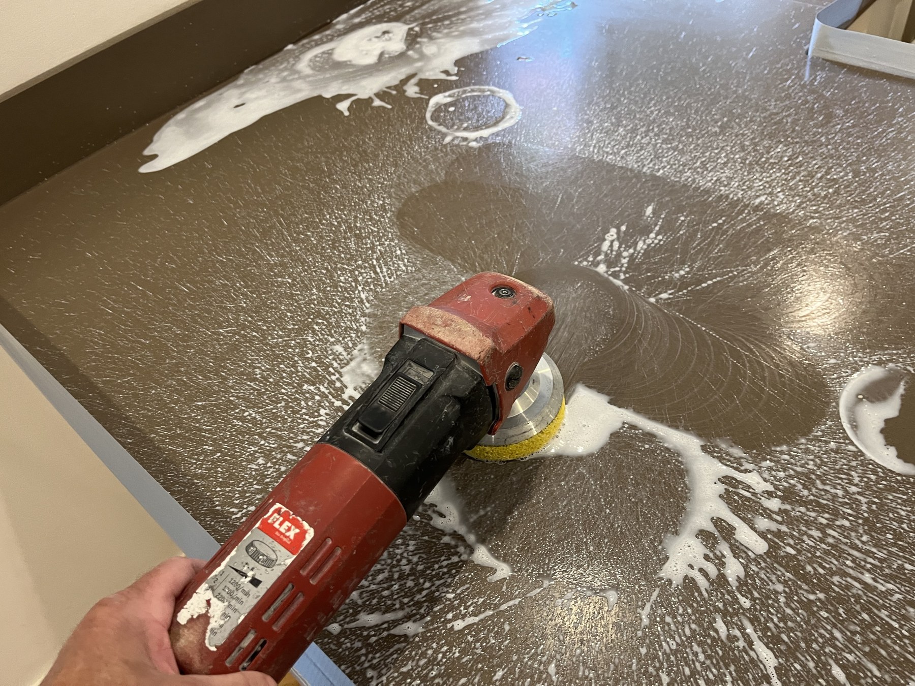 Quartz worktop being polished with a diamond pad and water