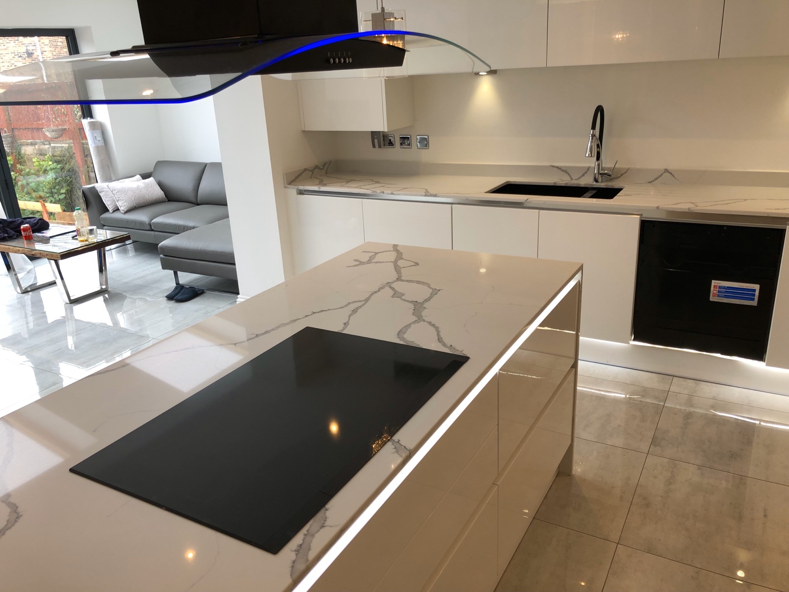Calacatta Superior quartz island with LED lighting, matching worktops and a black undermounted sink in East Ardsley, near Wakefield.