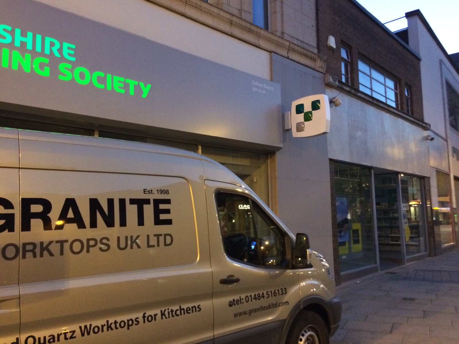 Exterior cladding at Yorkshire Building Society’s Oldham branch, with the Granite Worktops UK Ltd installation van outside.